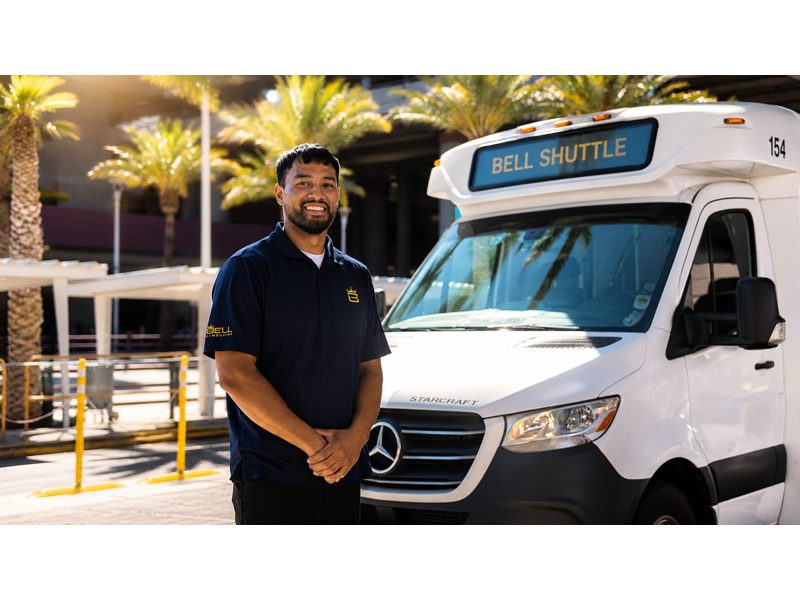 AIRPORT SHUTTLE Share-A-Ride Transfer - Professional Bell Trans driver welcomes guests aboard for reliable airport transportation.