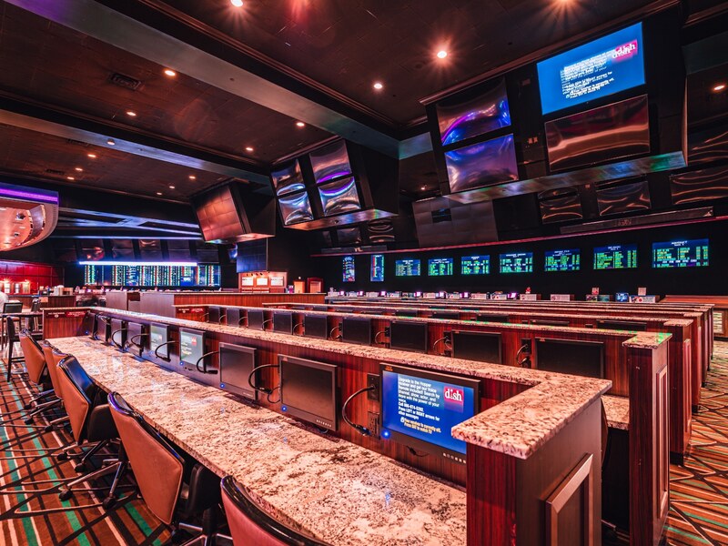 Bar seating and screens at the Boulder Station sportsbook.