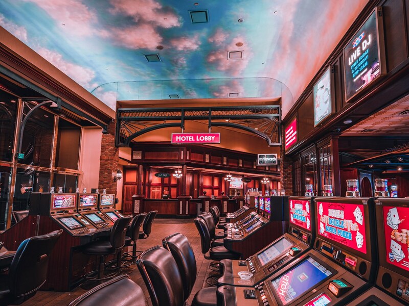Slot machines beneath Boulder Station's sky-themed ceiling.