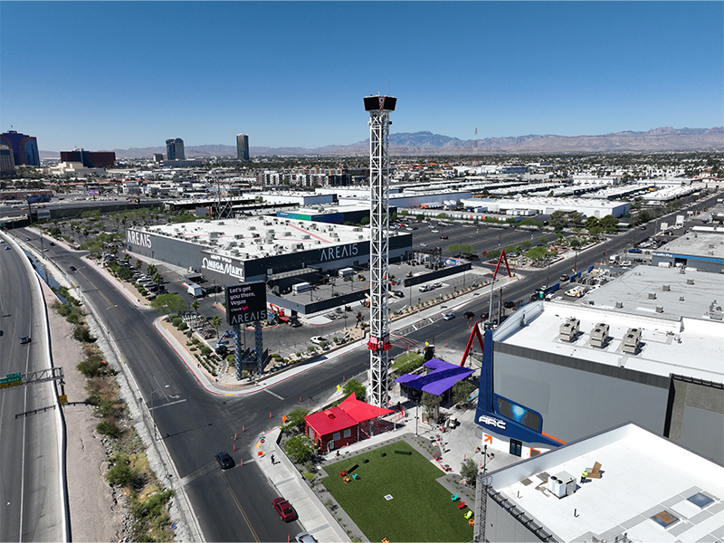 Eye Dropper - An aerial view of AREA15 showcases the towering Eye Dropper rising above the immersive entertainment district.