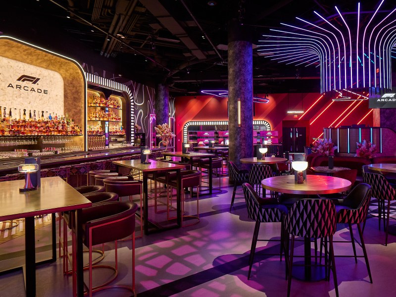 F1 Arcade Las Vegas - Neon lighting, lounge seating, and simulators create a high-energy racing atmosphere.