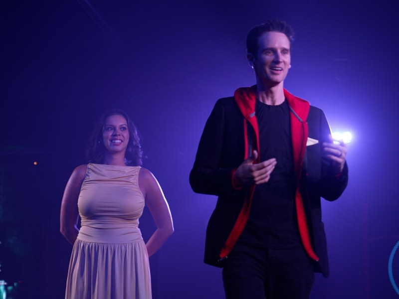 HACKED - Keelan Leyser shares a magical moment with a fellow performer under HACKED’s moody stage lighting.