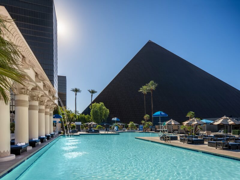 The Oasis Pool pairs sparkling water and poolside seating with a dramatic view of Luxor's iconic pyramid.