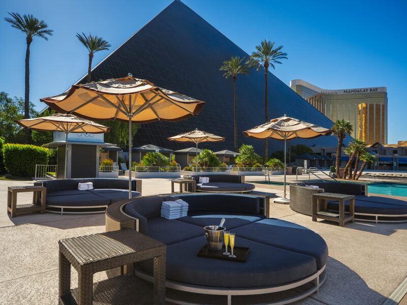 Plush round daybeds and umbrellas create a laid-back place to unwind near the Oasis Pool with pyramid views.
