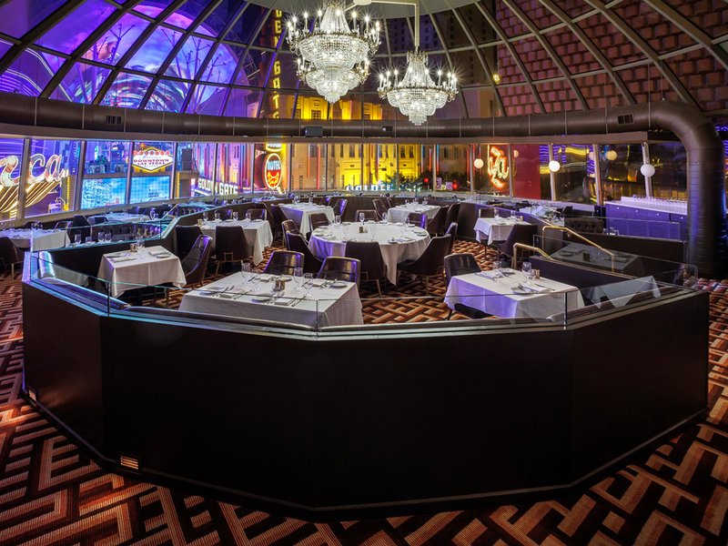 The elegant main dining room at Oscar's Steakhouse beneath its distinctive glass dome overlooking Fremont Street.