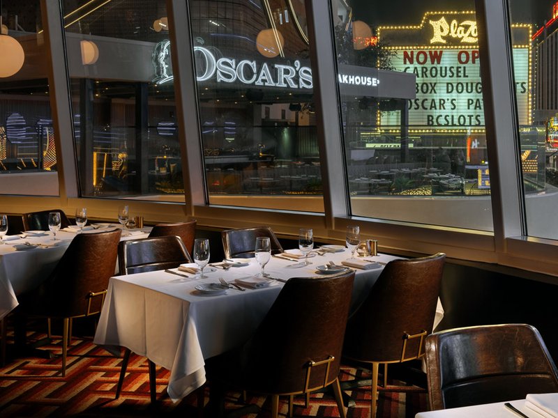 Interior dining at Oscar's Steakhouse combines vintage Vegas charm with sweeping downtown views.