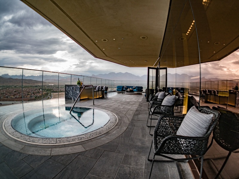 The One80 suite balcony creates a dramatic private retreat with an elevated spa, lounge seating and expansive desert views.