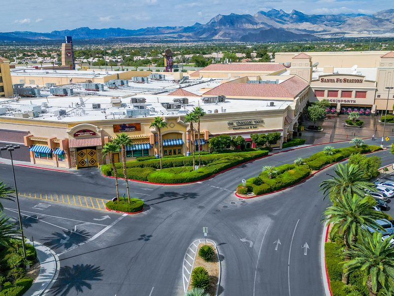An aerial view showcases Santa Fe Station’s expansive property, nearby dining and entertainment, and mountain backdrop.