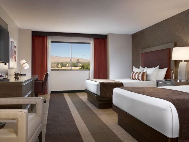 A two-queen guest room combines modern furnishings, workspace, seating and plenty of room for a comfortable Las Vegas stay.