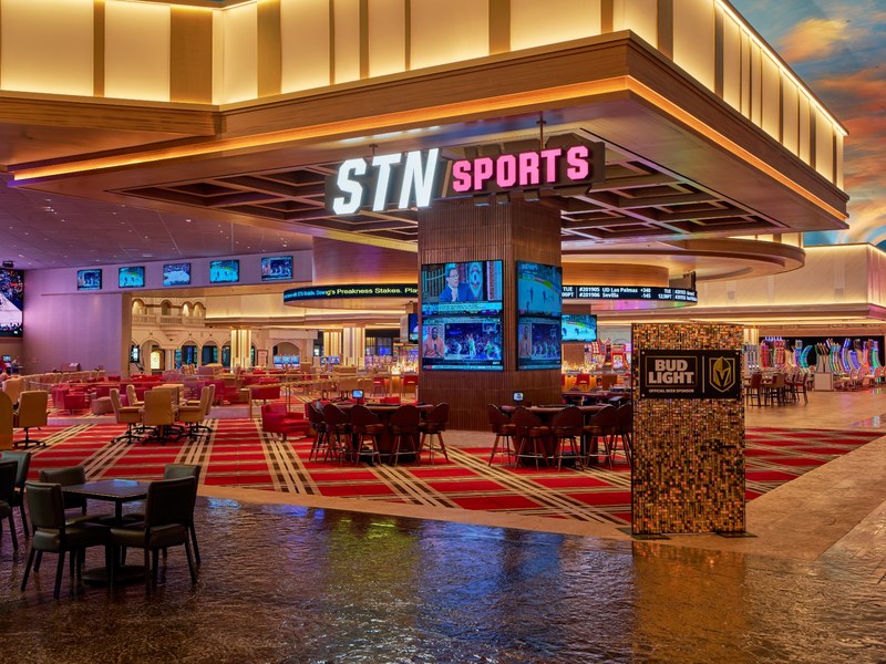 The STN Sports entrance opens into a sleek sportsbook area surrounded by screens, lounge seating and the energy of the casino floor.