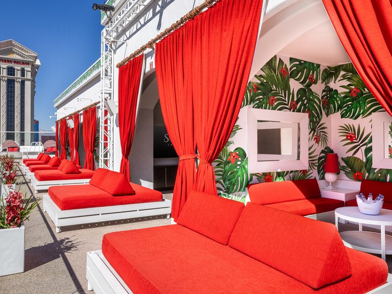 Poolside cabanas provide a private escape with comfortable loungers, shaded seating, and Strip views.